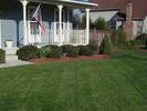 Front porch and boxwoods, stage left.